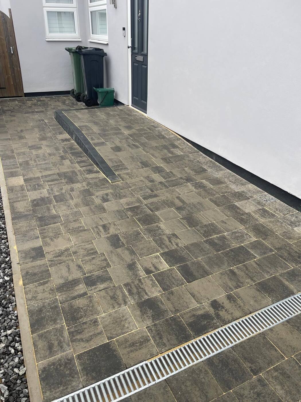 Charcoal block paving driveway with linear channel drain, Essex